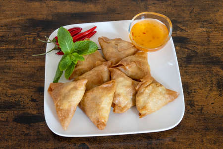 top view of samosa in a white plate with sweet and sour sauceの写真素材