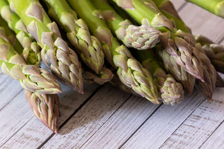 Fresh green asparagus on wooden background, close up.の写真素材
