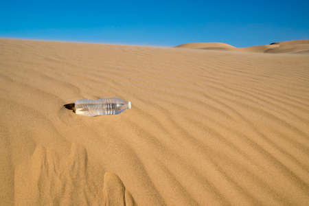 Bottle of Water in the Desert Sand Dunesの写真素材