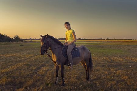horse rider at sunsetの写真素材