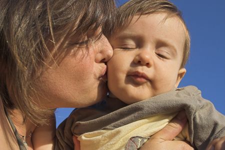mother kissing her sonの写真素材