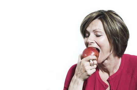 woman eating and apple  over white backgroundの写真素材