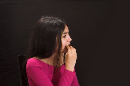 teen posing and improvising over black backdropの写真素材