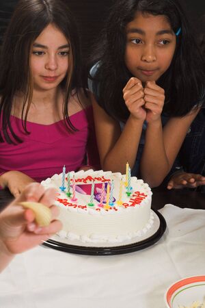 teen celebrating birthday with her picture on cake