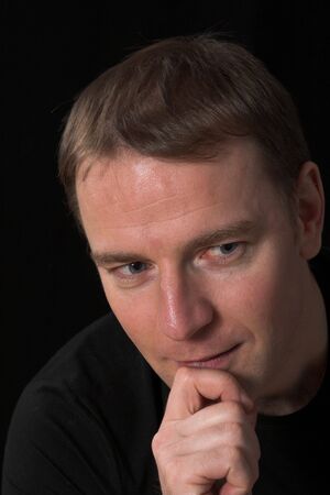 face close up of a man over black background