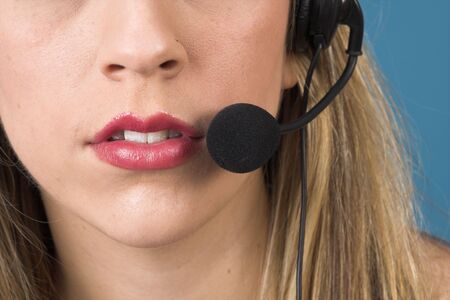 macro of receptionist with headset over blue dropの写真素材