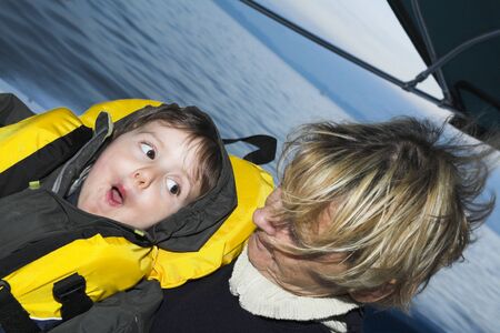  with grandmother on a boat doing faces