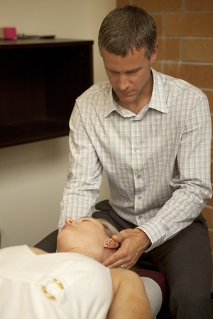 chiropractor with patient at a chiropractic clinicの写真素材