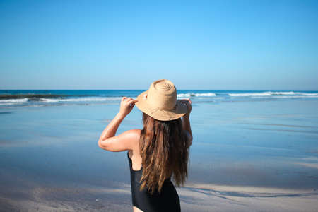 A pretty girl on the beach enjoying a sunny dayの写真素材