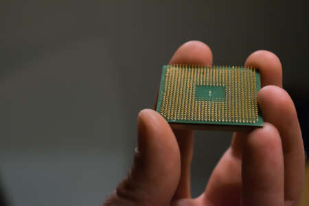 Hand holding an old processor. Technology that virtually grows old before you get it.