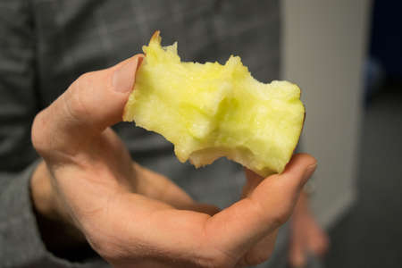 Hand with apple core.  Just finished eating a delicious fruit