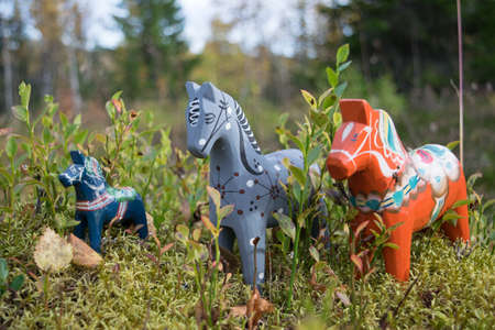 carved horse in forest lanscape with foal