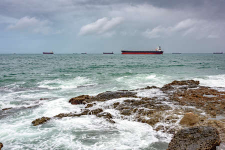 Ships anchored in the Bay of Todos os Santos in Salvador during bad weather waiting to moor in the harbor.の写真素材