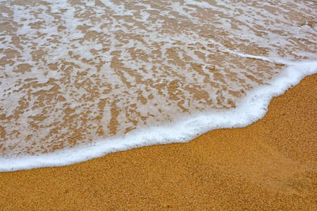 Water moving on the sand on the beach in Ilhabela in São Paulo