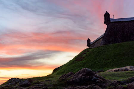 Sunset in Salvador city seen alongside the walls and watchtowers of the fort and lighthouse of Barraのeditorial素材