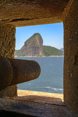 Cannon at the Fortress of Santa Cruz directed to the Guanabara Bay entrance and responsible for the defense of Rio de Janeiro at the time of the empire. You can see the Sugar Loaf hill in the background.の写真素材