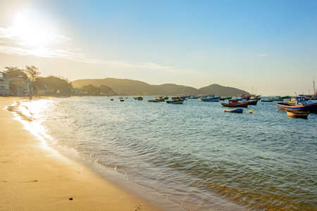 Sunset on the beach in Buzios with their boats and landscapeの写真素材