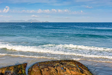 Devil's beach sea with the Niteroi town's hill in the backgroundの写真素材