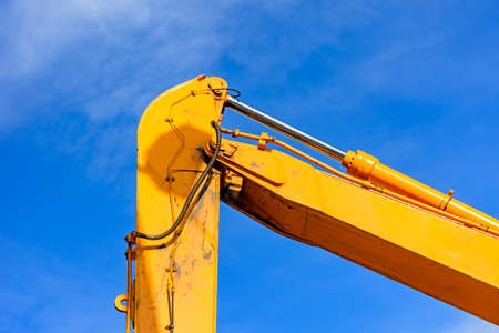 Detail of the joints and gears of a crane with blue sky in the backgroundの写真素材