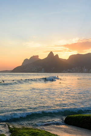 Landscape of the beaches of Arpoador, Ipanema and Leblon in Rio de Janeiro During dusk with the waves, surfers, hill Two brothers, Vidigal and G?¡vea stone in the backgroundの写真素材