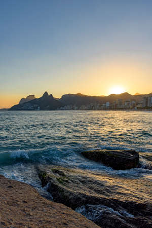 Sunset at Arpoador beach with Ipanema, Leblon, Twoo Brothers hill and Gavea Stone in the backgroundの写真素材