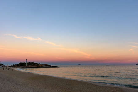 Landscape of Arpoador beach in Rio de Janeiro during dusk