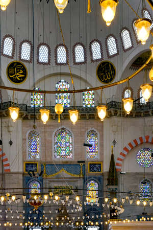 Chandeliers and their lights illuminating the interior of ancient mosque in Istanbul, Turkeyのeditorial素材