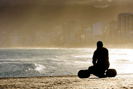 Skateboarder in front of the sea during late afternoon at Arpoador beach in Ipanema, Rio de Janeiroの写真素材