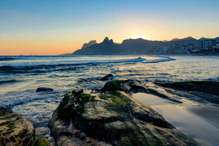 Summer sunset and stones at Ipanema beach in Rio de Janeiroの写真素材