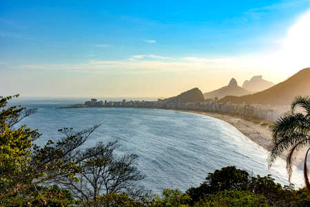 View from top of Copacabana beach with the hills and mountains of Rio de Janeiro in the backgroundの写真素材