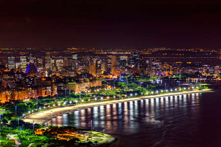Night view of the top of the Rio de Janeiro downtown with city lights, buildings, beach and streets on a summer nightの写真素材