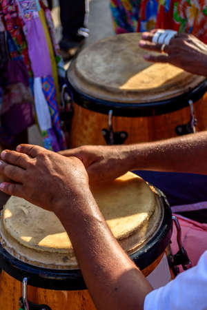 Percussionist playing atabaque during folk samba performance on the streets of Rio de Janeiroの写真素材