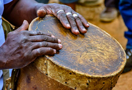 Percussionist playing a rudimentary atabaque during afro-brazilian cultural manifestationの写真素材