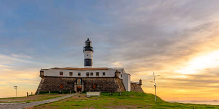 View of the famous Barra Lighthouse in Salvador, Bahia during sunset in summer in northeast Brazilの写真素材