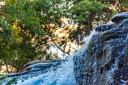 Small waterfall with water running on rocks in Carrancas, Minas Gerais, Brazilの写真素材