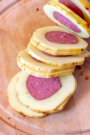 Slices of traditional Brazilian cheese stuffed with salami and topped with pepperoniの写真素材