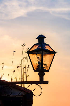 Old street lighting with lantern in colonial style during sunset in the city of Ouro Pretoの写真素材