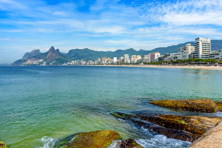 Ipanema beach in Rio de Janeiro still empty with its buildings and mountains aroundの写真素材
