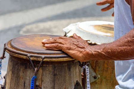 Musician playing a traditional Brazilian percussion instrument called atabaque during a capoeira performance on the streets of Pelourinho in Salvador, Bahiaの写真素材