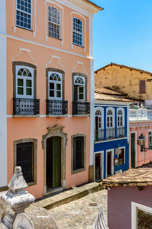 Old olorful facades of colonial-style houses on a cobblestone street in the Pelourinho neighborhood...