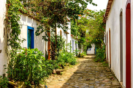 Beautiful street of the historic city of Paraty with its cobblestones and old colonial-style houses with a facade with plants and flowersの写真素材