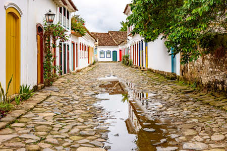 Cobblestone street with colorful colonial houses and reflections in the puddles in the historic city of Paraty, Rio de Janeiro, Brazilの写真素材