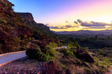 Small road between the rocks and mountains of Lavras Novas, municipality of Ouro Preto, Minas Gerais during sunsetの写真素材