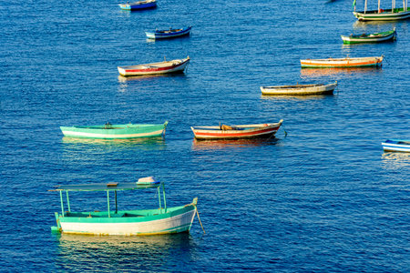 Rustic wooden fishing boats in the sea of the city of Salvador in Bahiaの写真素材