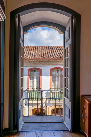 Old colonial houses in the historic city of Ouro Preto seen through the doors of a typical house in the city in the state of Minas Geraisの写真素材