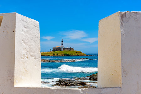 Famous Barra Lighthouse on the coast of the city of Salvador in Bahia seen between the walls of the Santa Maria fortの写真素材