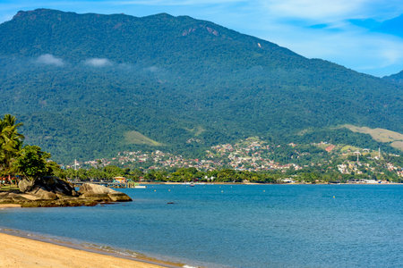 Seafront of the city of Ilhabela with its beaches, mountains and forests on a sunny dayの写真素材