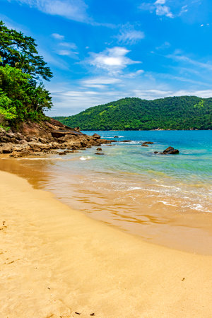 Remote and paradisiacal beach in Trindade, municipality of Paraty, surrounded by hills and tropical forestsの写真素材