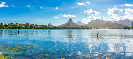 Rodrigo de Freitas Lagoon in Rio de Janeiro surrounded by the mountains and buildings of the cityの写真素材
