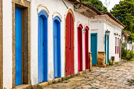 Facade of old houses in colonial architecture with their colorful doorsの写真素材